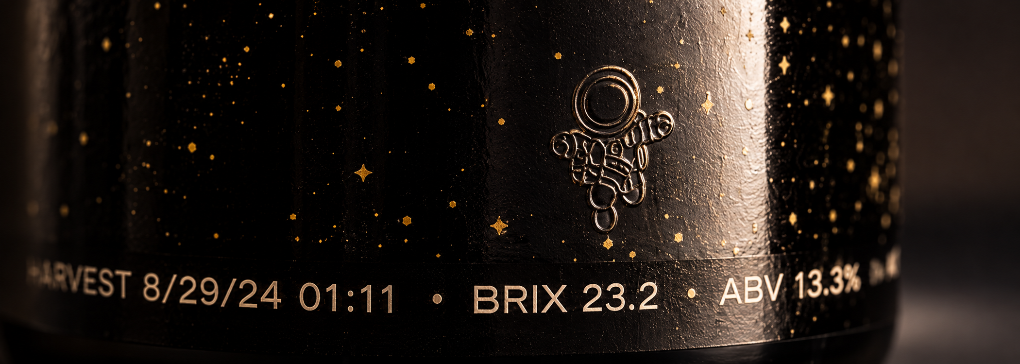 Curved black label with gold astronaut